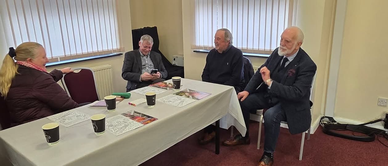 Guests chatting over tea around a table at our Miners Pit Talk, Kingston Road Community Hub